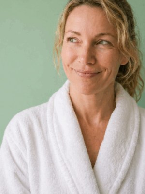 Woman smiling and wearing a spa robe in Arlington, TX